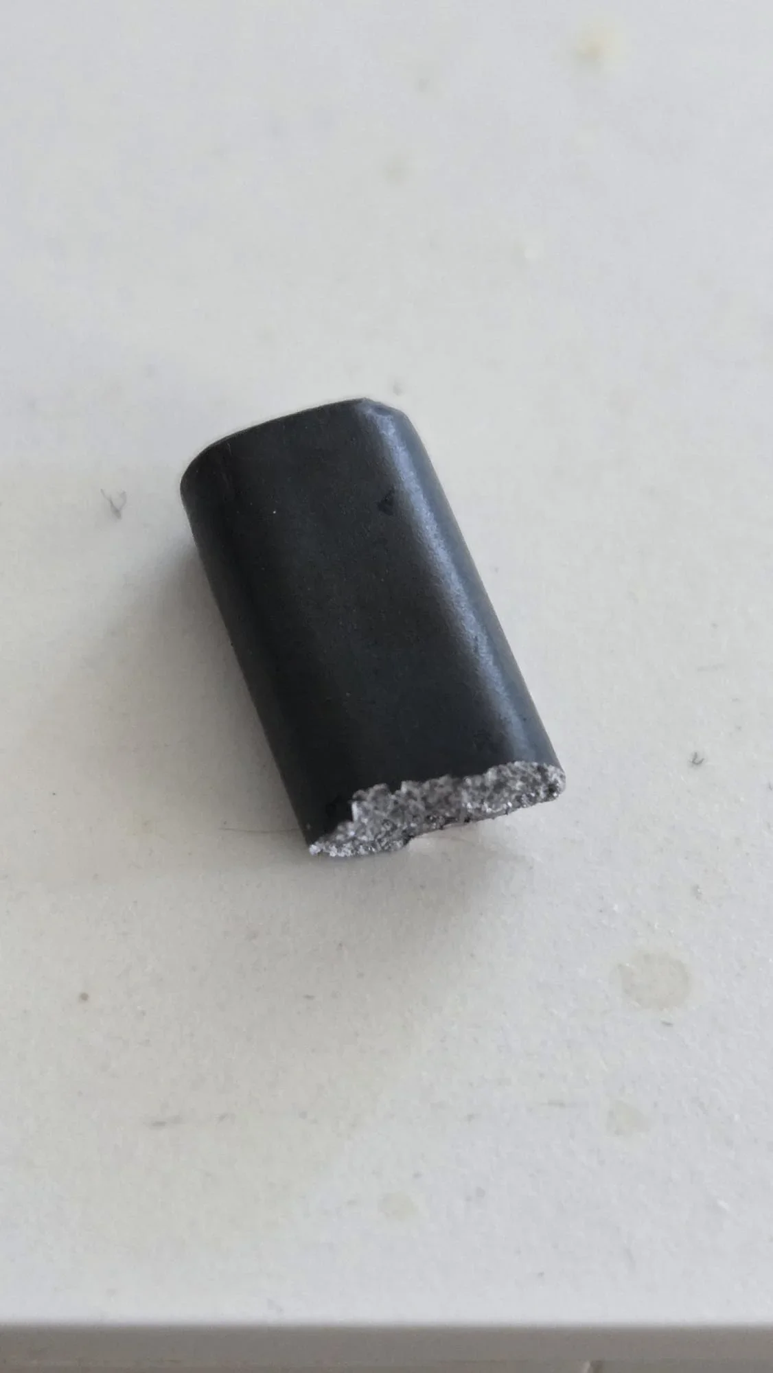 suspected broken piece from battery removal mechanism.webp